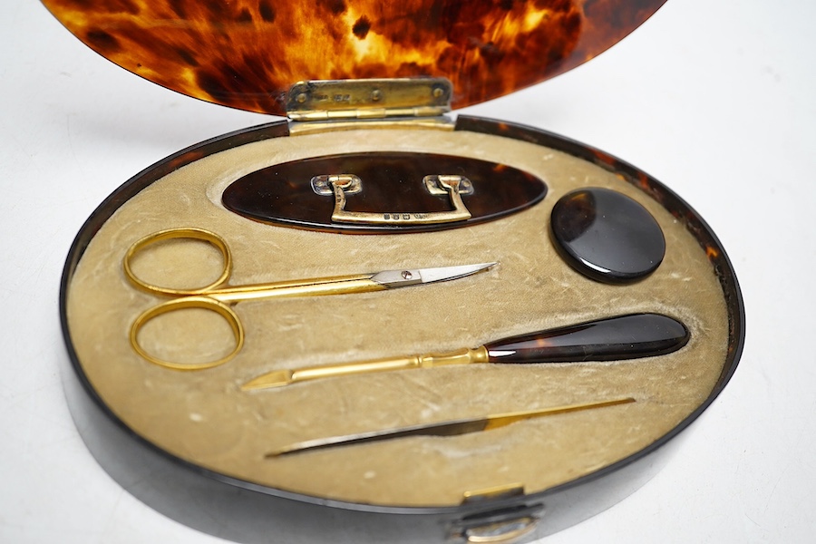 A George V silver gilt mounted tortoiseshell necessaire set, mm. C D, London 1922, 17.5cm wide. Condition - fair to good